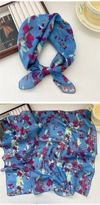Detail of floral chiffon scarf with royal blue base and vibrant abstract flower patterns