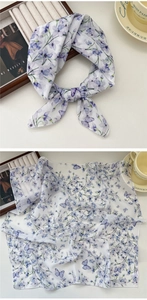 Detail of floral butterfly pattern on a white breathable cotton linen neck scarf