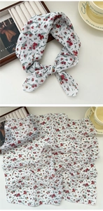 Detail of floral chiffon scarf with red blossom pattern and soft breathable fabric