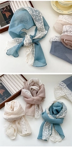Detail of elegant lace and linen scarf with delicate floral patterns and stitching