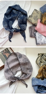 Detailed view of paisley print headscarf with delicate wavy scalloped edges and floral pattern