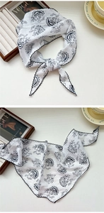 Detail of white paisley silk scarf with black scalloped embroidery and French chic style