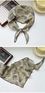 Detail of paisley print triangle scarf with scalloped lace edge and cotton linen texture