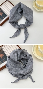 Detail of blue floral cotton linen scarf showing delicate white print and soft texture