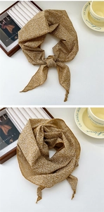 Detailed flat lay of ginger floral cotton linen scarf with coffee cup and accessories