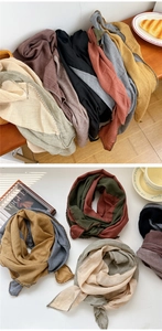 Detail of multi-color cotton linen scarves with contrast stitching and natural texture