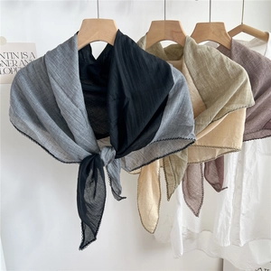 Fashionable rhombus cotton linen scarves in multiple colors on a wooden hanger