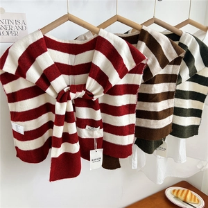 Striped knit shawl capelet for women in red, brown, and green with a front tie design