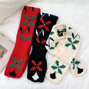 Three knitted floral scarves in red, black and beige with soft thick knit texture