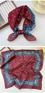 Détail d'un foulard en lin bordeaux avec motifs floraux blancs et motifs de soleil