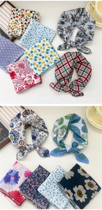Detail view of assorted cotton linen silk scarves featuring floral and polka dot prints
