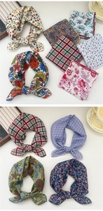 Close-up of assorted cotton floral and checkered neckerchiefs with pre-tied bow details