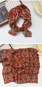 Detail view of a vintage red floral silk square scarf with a delicate edge finish