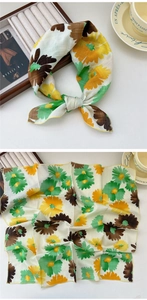 Close-up of floral print cotton-linen scarf with yellow sunflower patterns and edge detail