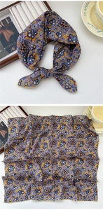 Detailed close-up of floral cotton-linen square scarf with fine stitched edges and patterns