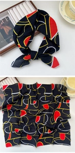 Detail of geometric cotton linen scarf with black base and red yellow abstract patterns