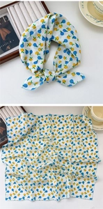 Close-up of linen cotton square scarf with fruit pattern and blue stitched edges