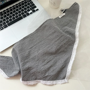 Detail of black and white gingham cotton bandana with delicate white lace trim and brand label
