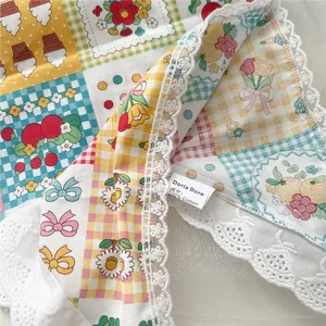 Detail of 100% cotton headscarf showing intricate lace trim and mixed floral patterns