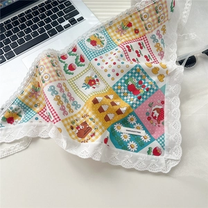 Close-up of vintage floral cotton headscarf with delicate white lace edge detailing