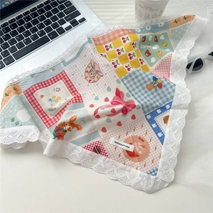 Close-up of 100% cotton floral triangular scarf with lace trim and cute bunny patterns