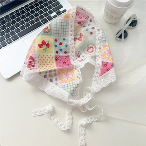 Detail of vintage French floral lace headscarf with strawberry patchwork design