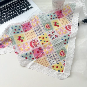 Detail of 100% cotton lace-trimmed bandana featuring sweet floral and strawberry patchwork