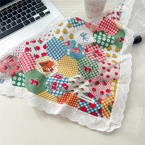 Close-up of 100% cotton lace triangle scarf with strawberry duck patterns and label