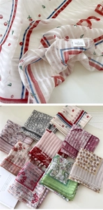 Detail of vintage floral cotton linen scarf showing fabric texture and various print patterns
