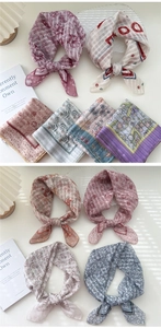 Macro detail of various floral cotton linen scarves with elegant printed patterns
