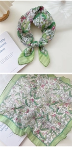 Detail of floral green cotton linen scarf showing soft texture and petal patterns