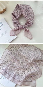Detail of light purple floral cotton linen scarf with soft flower prints and striped borders
