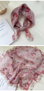 Close-up of light pink floral cotton linen scarf with fine grid pattern and soft texture