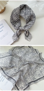 Detail of floral linen scarf showing vintage flower pattern and striped edge border