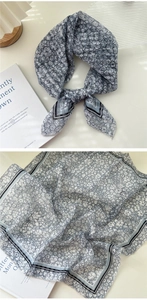 Detail of blue floral cotton linen scarf with vintage pattern and striped border