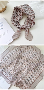 Detailed view of lightweight polka dot scarf with premium hemmed edges and sheer texture