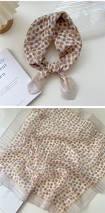Detailed view of lightweight floral polka dot linen scarf showing texture and drape