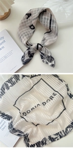 Macro detail of sheer cotton-linen scarf with elegant floral patterns and checked texture