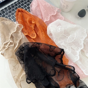 Detailed embroidery view of lace scarves featuring ginkgo leaf patterns in five colors