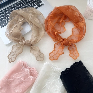 French style floral lace headscarf in assorted colors on a desk with laptop and coffee
