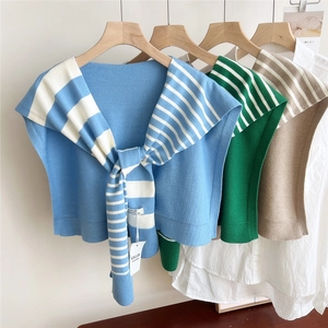 Detailed knit texture of striped shawls in sky blue, emerald green and beige colors