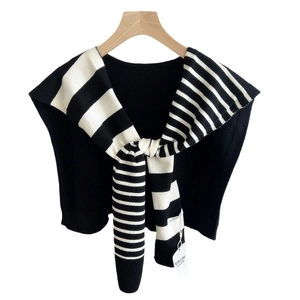 Elegant black vest with striped knit shawl wrap, minimalist retro style on hanger
