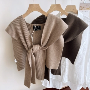 Vertical ribbed knitted shawl shrug in khaki and brown colors with a front knot design