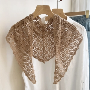 Detail of vintage crochet lace shawl featuring intricate floral hollow-out patterns