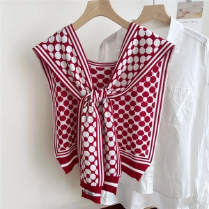 Detail of red and white knit shawl with floral pattern and nautical collar style