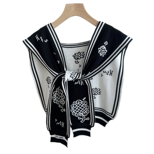 Black and white floral knit shawl with sunflower pattern and nautical tie closure