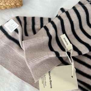 Striped wool knit shawl for women featuring black and beige patterns on 100% wool fabric