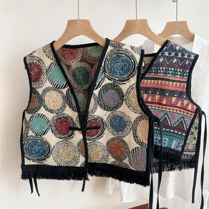 Ethnic knit shawl vest with colorful jacquard patterns and black fringe tassels