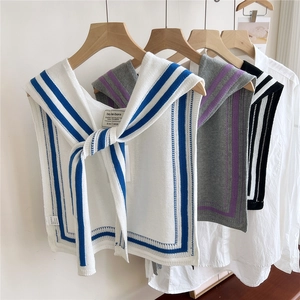 Knitted nautical stripe shawls in various colors on wooden hangers for styling