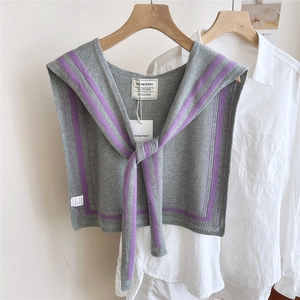Detailed knit grey shawl with purple stripe trim and tie-front knot on white shirt